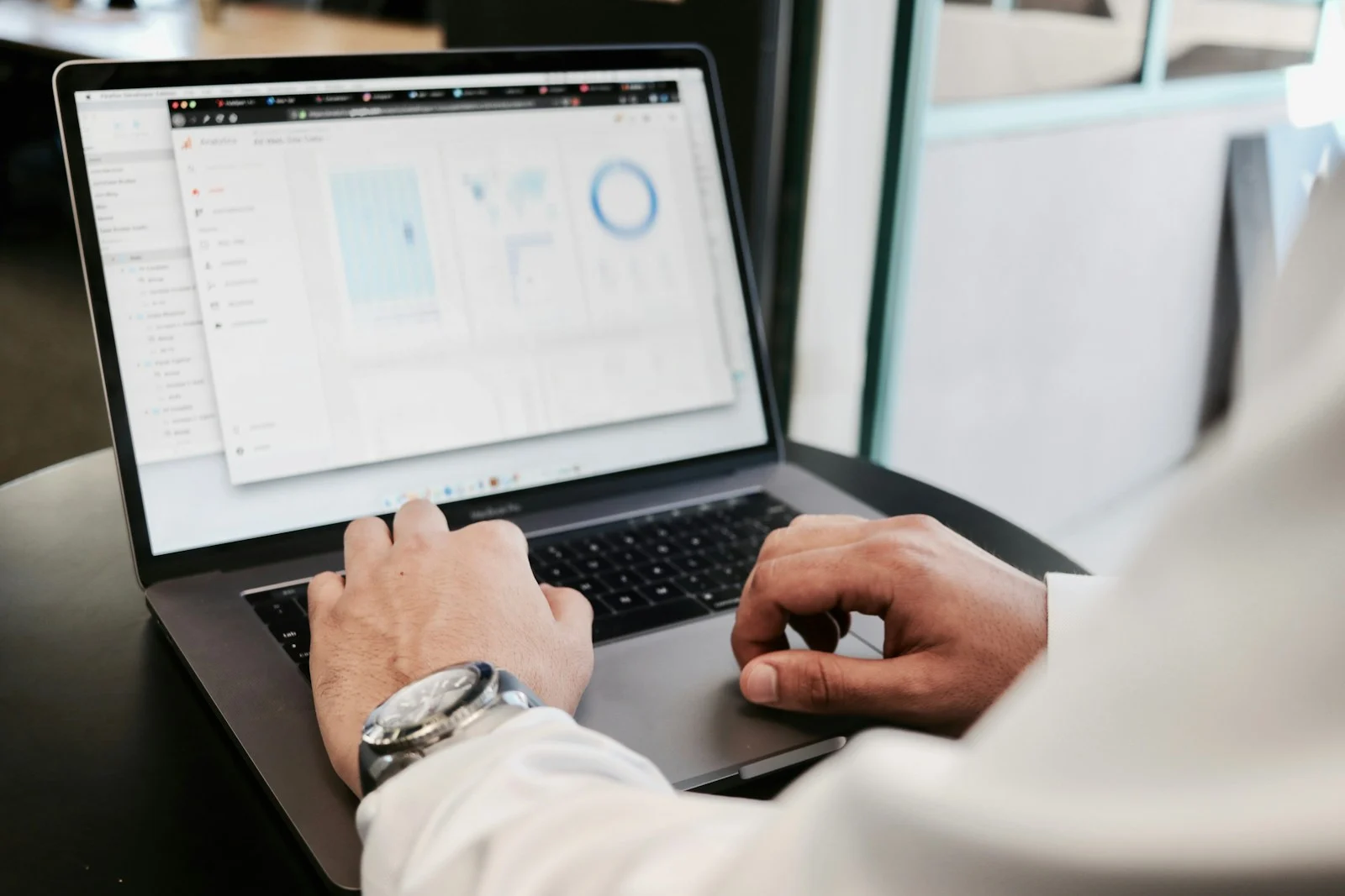 person using MacBook Pro. Health Economics and Outcomes Research.